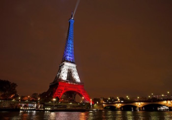 The Eiffel Tower is lit with the blue, white and red colours of the French flag in Paris, France, November 16, 2015, to pay tribute to the victims of a series of deadly attacks on Friday in the French capital. REUTERS/Benoit Tessier