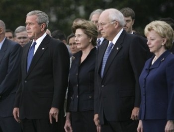 President Bush, left, along with, from second from left, first lady Laura Bush, Vice President Dick Cheney and his wife, Lynne Cheney, stand with White House staff and members of Congress as they take part in a moment of silence, marking the sixth anniversary of the Sept. 11 terrorist attacks, Tuesday, Sept. 11, 2007, on the South Lawn of the White House in Washington. (AP Photo/Lawrence Jackson)