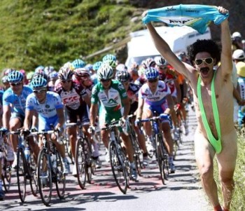 A half-naked supporter runs by the pack as it rides by during the eighth stage of the 94th Tour de France cycling race between Le-Grand Bornand and Tignes, 15 July 2007. Denmark's Michael Rasmussen won the stage and took the yellow jersey as overall leader. AFP PHOTO / FRANCK FIFE